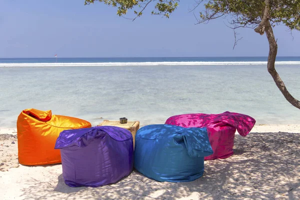 Colored sunbed and Umbrella under the tree in ocean view of Indonesia, Gili Trawangan island.