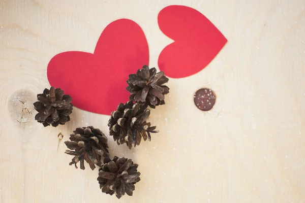 Kırmızı kağıt kalp ve çam kozalakları
