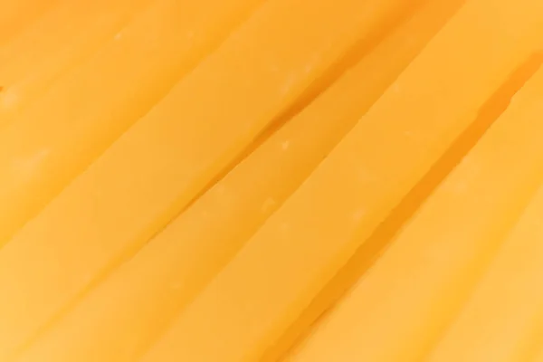 Fatias de queijo sólido macro closeup. Textura de fundo . — Fotografia de Stock