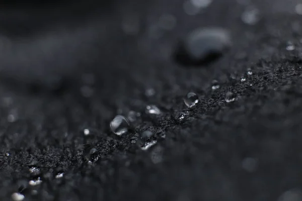 Water drops on black leather background texture. Macro Closeup. — Stock Photo, Image