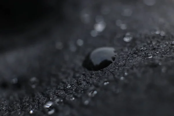 Water drops on black leather background texture. Macro Closeup. — Stock Photo, Image