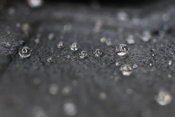 Small water drops on black leather background texture. Macro Closeup. — Stock Photo, Image