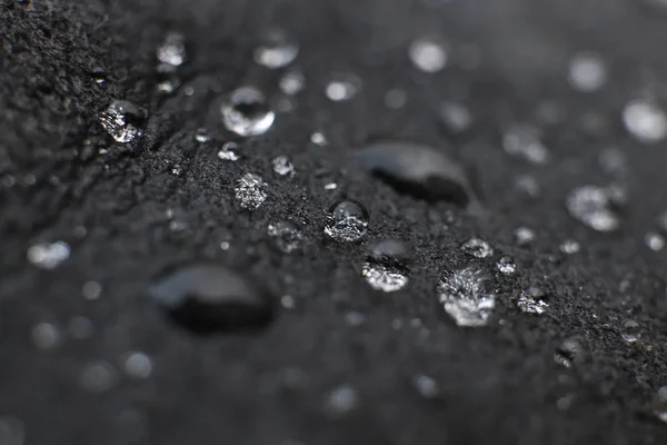 Elegant water drops on black leather background texture. Macro Closeup. — Stock Photo, Image