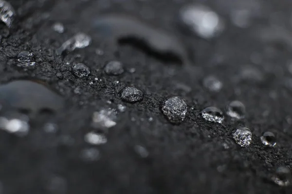 Water drops on black leather surface background texture. Macro Closeup. — Stock Photo, Image