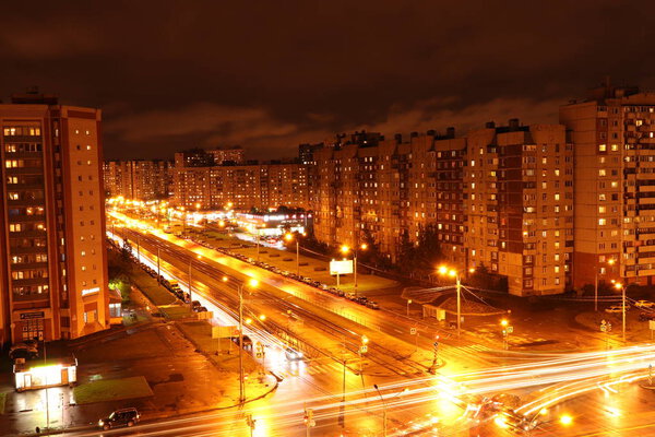 Night crossroad road lights exposure landscape. Living buildings on background.