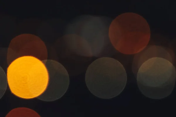 Unfocused evening lights. Yellow circles bokeh background. Blurred colored circles backdrop.