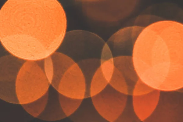 Unfocused evening lights. Yellow circles bokeh background. Blurred colored circles backdrop.