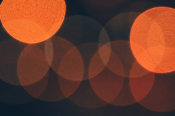 Blurred colored circles backdrop. Unfocused evening lights. Yellow circles bokeh background. — Stock Photo, Image