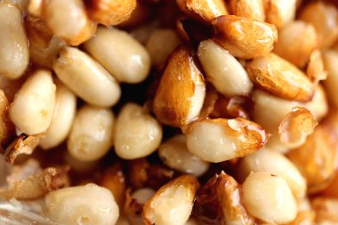 Bal içinde sedir kozalağı tohumları. Arka plan dolduruluyor.