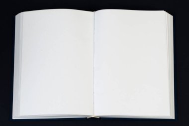 Tahta masanın üzerinde açık bir kitap.