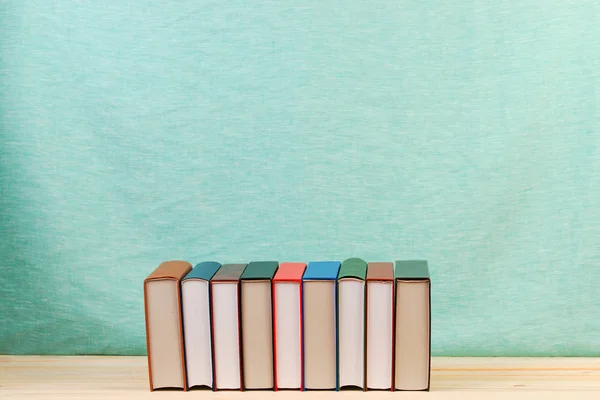 Stack of hardback books on wooden table. Back to school. — Stock Photo, Image