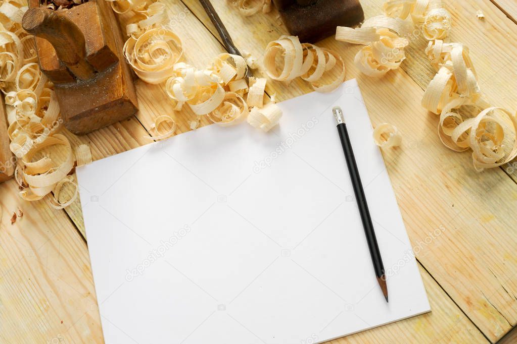 White sheet on wooden table for carpenter tools with sawdust.