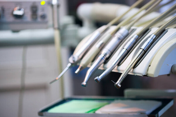 Stomatological instrument in the dentists clinic. Operation, tooth replacement.