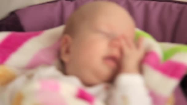 Bebé meciéndose en una cuna — Vídeo de stock