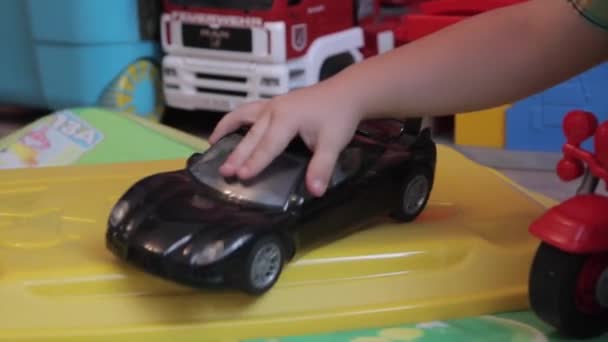 Un chico jugando con un coche — Vídeo de stock