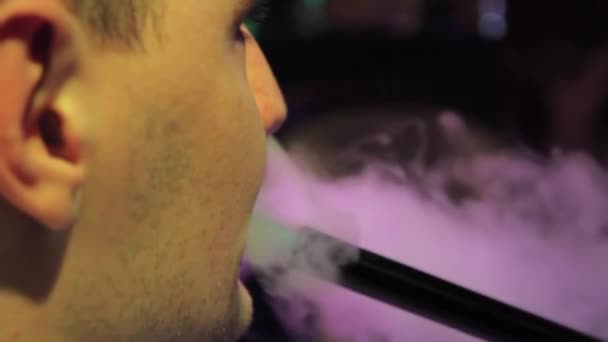 A man smokes a hookah in the restaurant — Stock Video