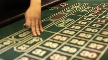 Bir kadın bir Casino rulet oynayarak bir bahis yapar.
