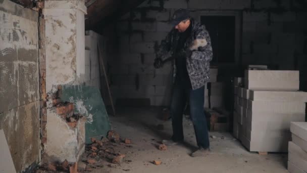 Homme brise mur de briques avec marteau de traîneau — Video