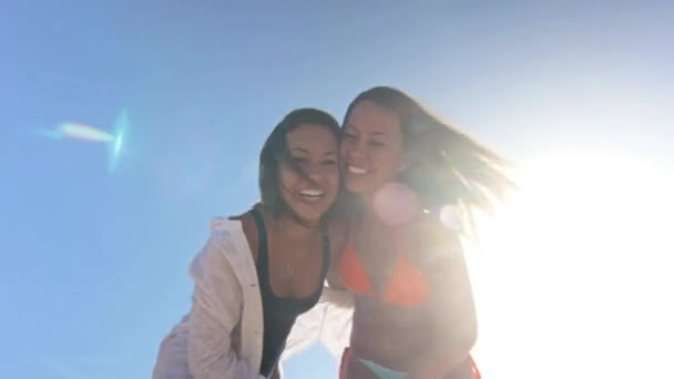 Сестры-близнецы улыбаются в камеру и обнимаются — стоковое видео