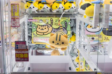 Tokyo, Japan - January 24, 2016:the claw machine in games arcade clipart