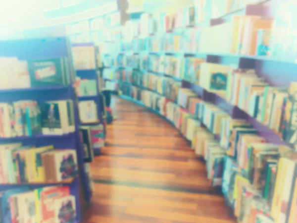 Vintage style color tone.Blur image of a bookstore — Stock Photo, Image