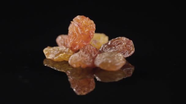 Raisins spinning on a black background — Stock Video