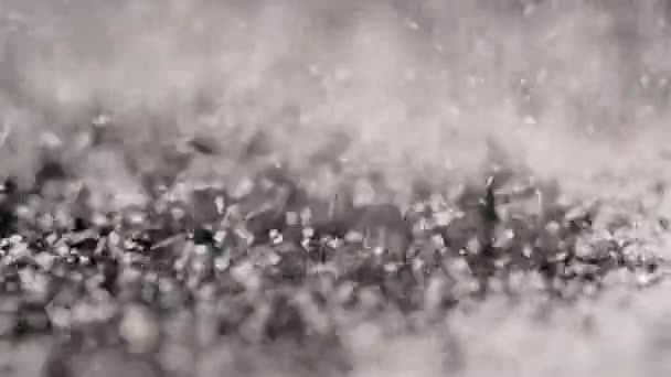 Close-up of sugar falling and spinning on a black background — Stock Video