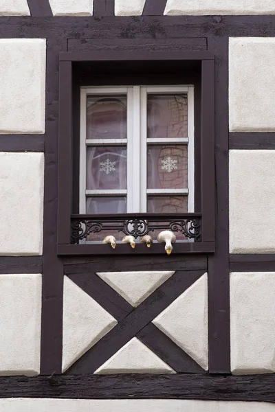 Detail of a window with bird sculptures on the edge