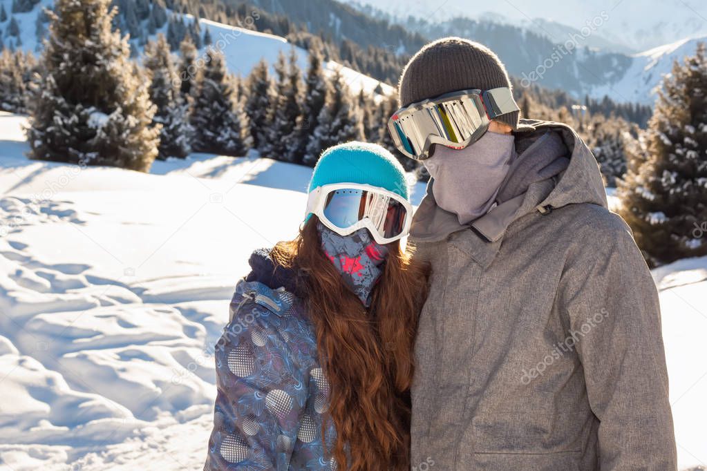 Couple snowboarder in place in the mountains
