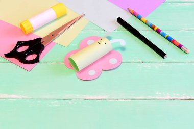 Eğlenceli kağıt kelebek el sanatları, makas, kağıt, kalem yeşil ahşap masa üzerinde renkli marker, yapıştırıcı. Araç ve Gereçleri kelebek el sanatları oluşturmak için. Yaz iskambil kağıt sanat projesi 