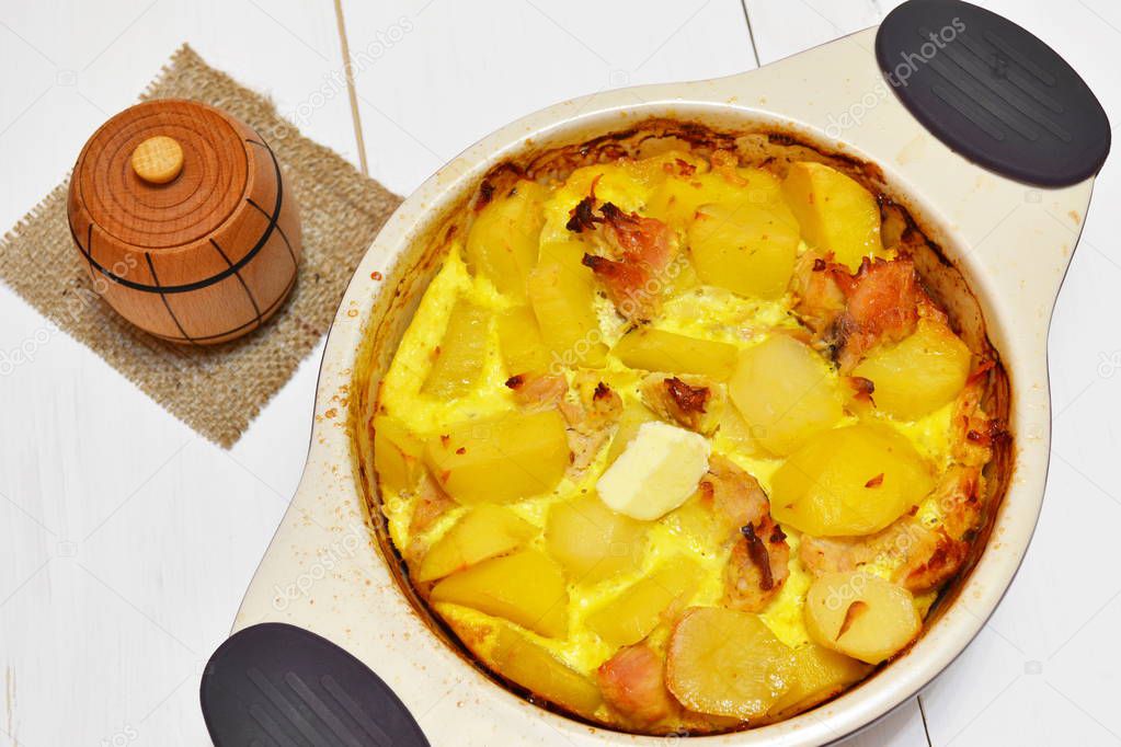 Potato gratin with meat. Delicious potato casserole with meat in a baking dish