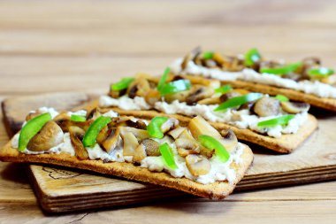 Kızarmış yağlı mantar ve ahşap bir tahta üzerinde taze yeşil biber ile lezzetli meze. Basit ve bol vejetaryen yemek. Ev tarifi. Portre