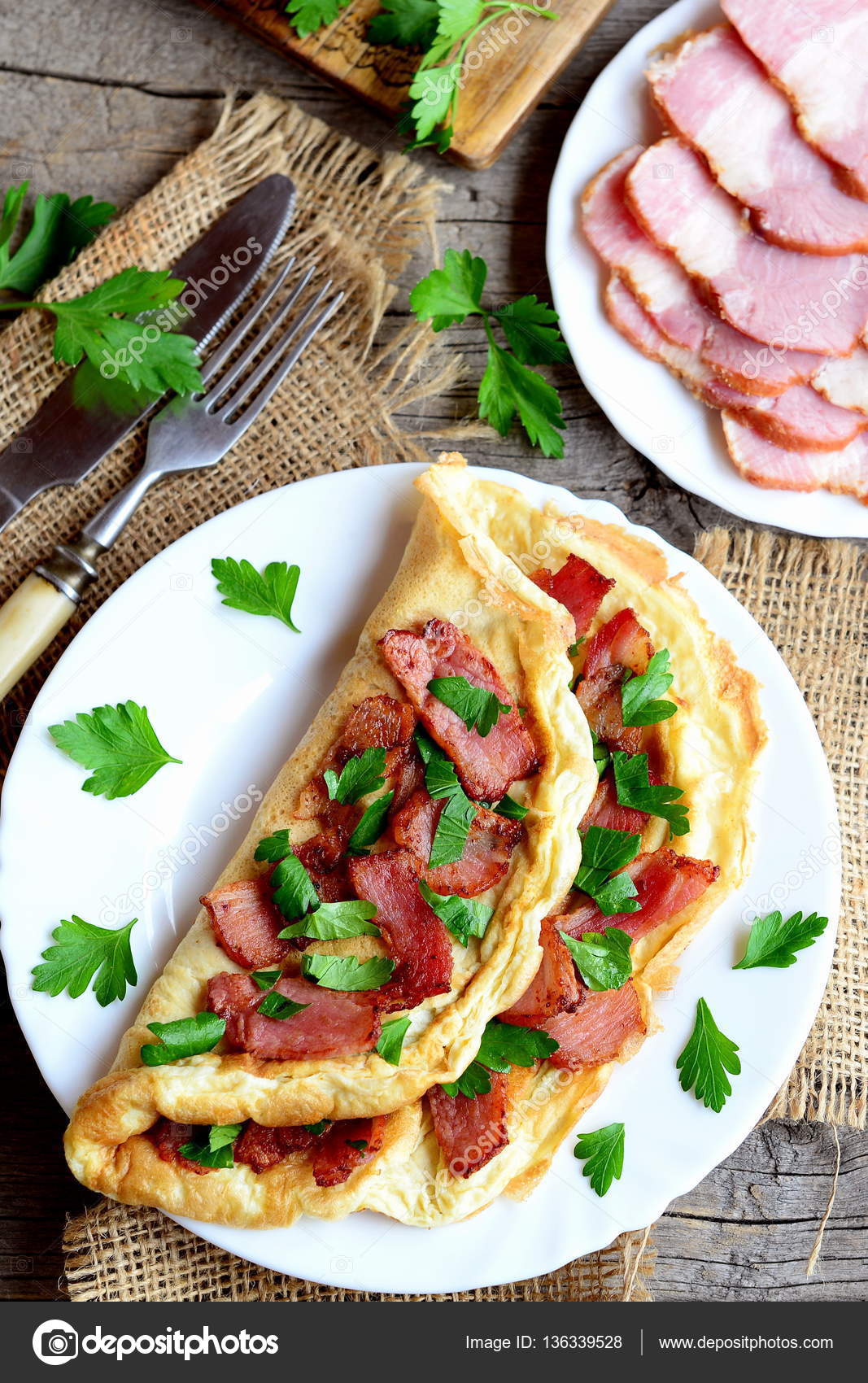 Tasty bacon omelette. Fried omelette stuffed with bacon and parsley for