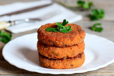 Ev yapımı havuç Burger bir plaka üzerinde. Yeşil soğan ve maydanoz ile lezzetli havuç hamburger. Portre