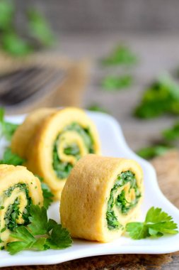 Peynir ve otlar omlet taze maydanoz ile süslenmiş alır. Kolay doldurulmuş omlet rendelenmiş peynir ve ince doğranmış otlar ile alır. Çocuk dostu kahvaltı fikir. Rustik tarzı. Dikey fotoğraf