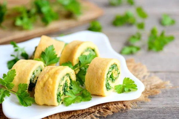 Rolos de omelete de queijo e salsa em um prato branco. Rolos omelete fritos em casa com queijo ralado e salsa finamente picada. Receita saborosa de omelete de ovo de baixo carboidrato. Estilo rústico — Fotografia de Stock