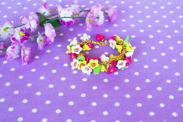 Beautiful floral bracelet on a lilac background