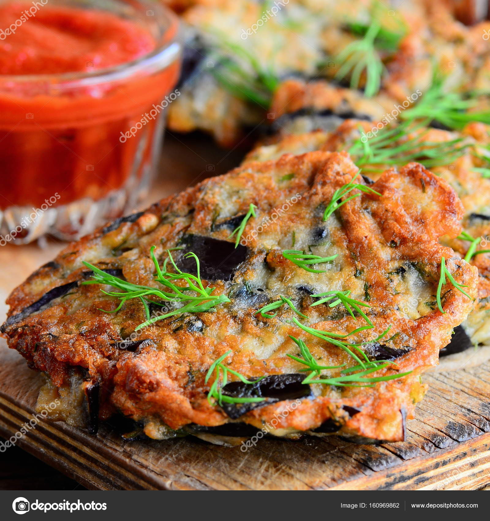 Simple fried eggplant cutlets with garlic and dill on a white plate and