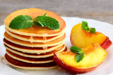 Tatlı Şurup ve beyaz bir plaka üzerinde ızgara nektarin krep. Ev yapımı tatlı krep tarifi. Lezzetli kahvaltı veya brunch çocuklar ve bütün aile için. Portre