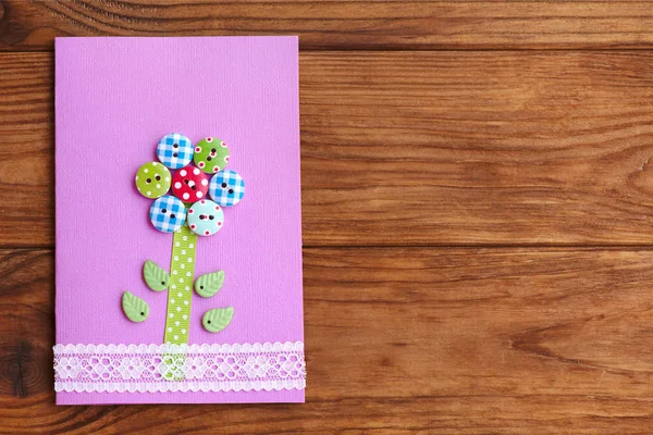 Happy Mother's day or birthday greeting card with flower isolated on a wood background with empty place for text. Card made with the use of wooden buttons, lace, paper, plastic leaves, glue, scissors — Stock Photo, Image