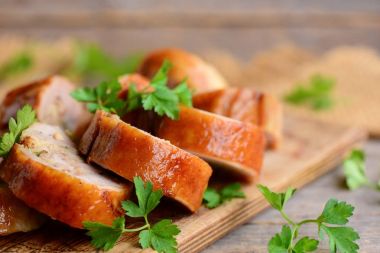 Lezzetli tavuk rulo ile doldurma. Dilimlenmiş tavuk dolması ile taze maydanoz bir ahşap tahta üzerinde rulo. Ülke stil