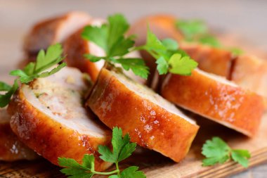 İştah açıcı tavuk rulo. Dilimlenmiş tavuk dolması bir ahşap tahta üzerine maydanoz ile rulo. Portre