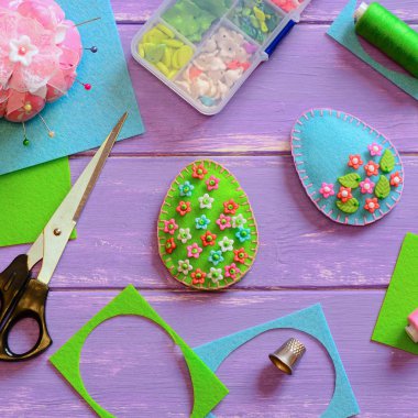 Paskalya yumurtası el sanatları ile renkli plastik boncuk. Yumurta süsleme yuva ve ahşap arka plan kopya alanı ile hissettim. Mutlu Paskalya tebrik kartı. Paskalya dekor el sanatları için bir fikir. Küçük dikiş projeler yeni başlayanlar için. El dikiş projeler