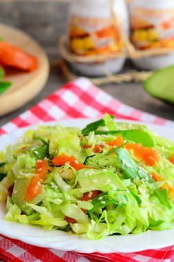 Kolay avokado lahana lahana salatası. Taze avokado, Kuru Kayısı, roka ve susam bir tabak ve ahşap bir masa ile diyet lahana salatası. Sağlıklı konfor gıda vejeteryanlar ve vegans için. Sağlıklı vejetaryen salata tarifi. Sağlıklı salata tarifi Hint