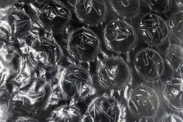 Close Up of Round Bubble Wrap on Top of Shiny Paper to Make an Abstract Background