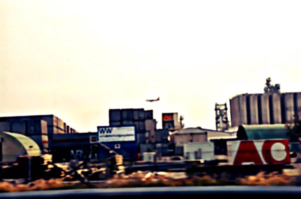 Industrial industry buildings complex zone, abstract blur and without readable marks. Apocalyptic civilization theme.