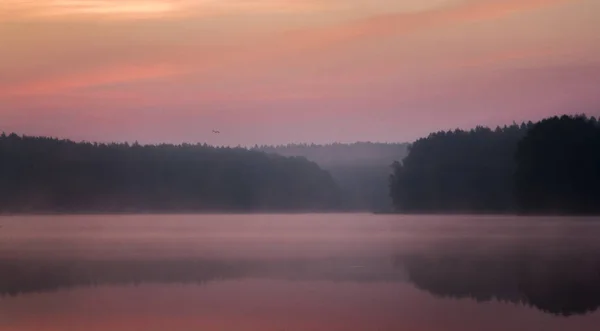 Beautiful sunrise over the water and mist — Stock Photo, Image