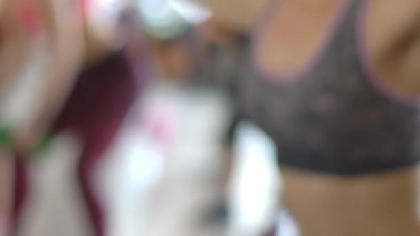 Женщина в спортзале делает упражнения с гантелями — стоковое видео