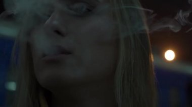 Gerçek zamanlı kız ışıklar ve bir sigara içiyor