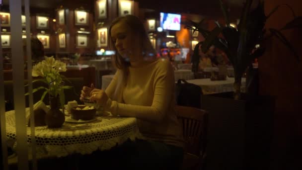 女孩与一杯咖啡在咖啡厅 出神地看着街上的生活 — 图库视频影像